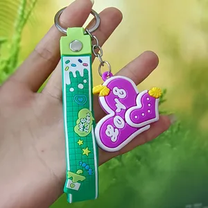 Macro detail of a 3D purple silicone heart keychain with a green decorative strap