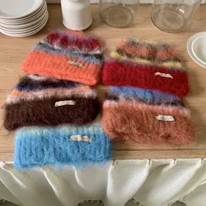 Assorted colorful fuzzy mohair knit beanies with striped patterns for winter warmth
