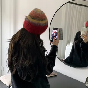 Chic colorful striped fuzzy beanie shown in a lifestyle mirror selfie detail view