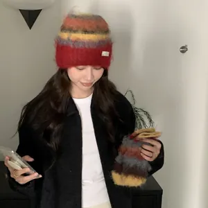Close-up of cozy Korean-style multi-color fuzzy beanie and matching warm gloves worn by model