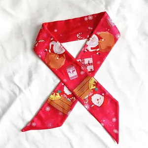Detailed view of red Christmas skinny scarf with Santa and gift patterns for bags.