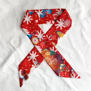 Detail shot of red Christmas silk ribbon with Merry Christmas print and snowflakes.