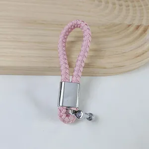 Stylish pink braided PU leather car keychain with a silver horseshoe buckle accessory