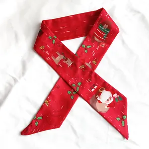 Detailed close-up view of a festive red Christmas skinny scarf with Santa and reindeer motifs