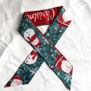Macro view of Christmas themed silk scarf featuring Santa and Snowman print patterns