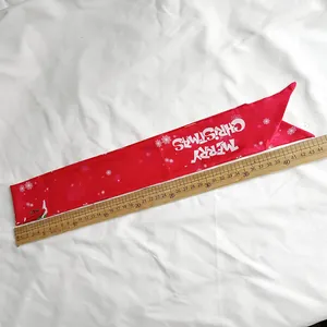 Detailed view of red Christmas ribbon with ruler showing 44cm length