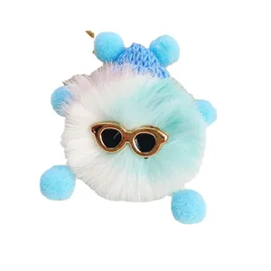 Cute fuzzy blue and white plush coal ball keychain with stylish sunglasses and soft pom poms