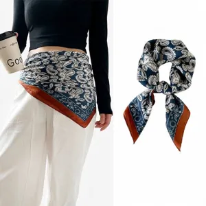 Elegant navy blue silk scarf with paisley pattern styled as a waist belt on a model