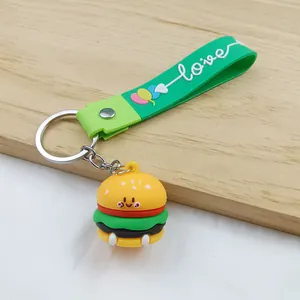 Close-up detail of a cute cartoon hamburger keychain with a green 'love' silicone strap