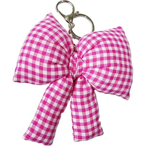 Nahaufnahme eines niedlichen rosa-weiß karierten Stoff-Schlüsselanhängers für Taschen