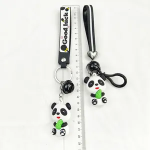 Macro view showing the size of a cute panda keychain holding a green bamboo leaf