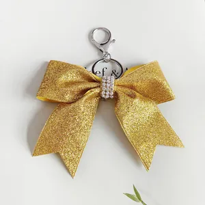 Elegante portachiavi con fiocco dorato glitterato e strass per decorazioni natalizie