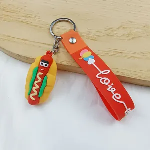 Close-up detail view of a cartoon hotdog keychain featuring an orange silicone Love strap