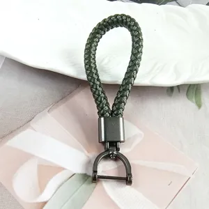 Detail shot of dark green braided keychain with gunmetal horseshoe buckle clasp.