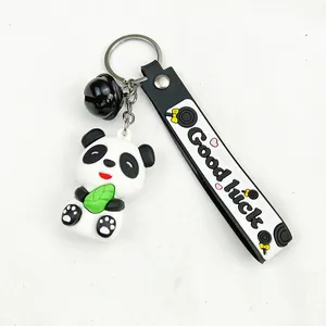 Close-up of cute cartoon panda keychain with Good Luck PVC strap and black bell charm