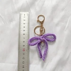 Purple handmade crochet bow keychain with pearl charm for cute bag decoration