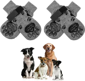 Anti-slip grey pet socks with adjustable straps shown with four different dog breeds