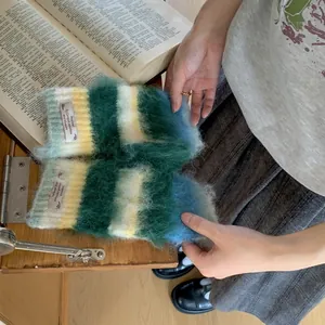 Close-up detail of fuzzy mohair striped arm warmers with an aesthetic decorative label