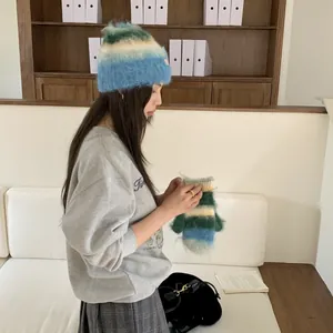 Detailed view of fuzzy mohair beanie and matching mittens with blue green gradient stripes
