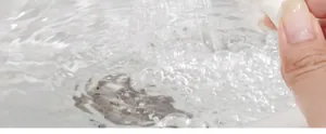 Close-up of pet comb being rinsed under running water for easy cleaning process