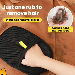 Detailed view of black mesh pet hair removal glove cleaning cat fur off brown fabric