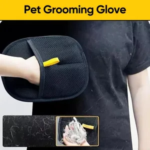 Close-up of static pet hair removal glove cleaning fur from black fabric surface