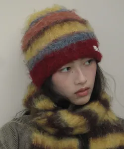 Close-up detail of a colorful striped fuzzy beanie and matching scarf set for winter