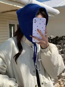 Winter warm blue knitted balaclava hood scarf shown in an outdoor lifestyle setting