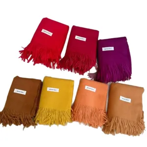 Soft solid color thick knit winter scarves with tassels in various vibrant shades