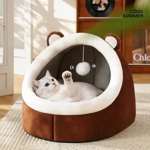 Semi-enclosed warm plush pet bed featuring a hanging pom-pom toy and cute bear ears