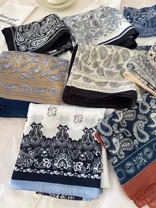Close-up detail of soft silk scarves featuring intricate paisley patterns in multiple colors