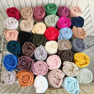 Macro view of multi-colored pleated cotton blend hijabs neatly organized in a basket