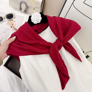 Soft burgundy pleated cotton-feel square scarf styled as a shawl over a white dress