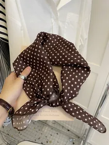 Detailed close-up showing texture and pattern of a brown polka dot cotton linen neck scarf