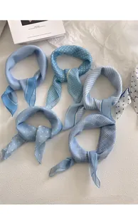 Detailed view of blue patterned neckerchiefs with polka dots, stripes, and checks