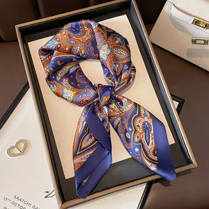 Detailed shot of a luxury vintage paisley pattern silk square scarf on display board