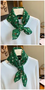 Detail showing a green floral cotton neckerchief tied in a knot over a white long sleeve top