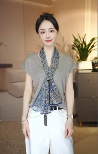 Elegant blue paisley pattern silk scarf for women styled with a casual indoor outfit