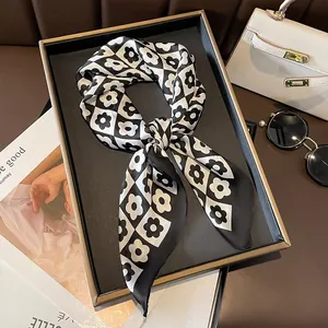Floral checkerboard silk square scarf on tray with fashion accessories