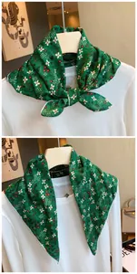 Close-up of green floral cotton square scarf styled on a white top with details.