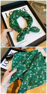 Detail view of green floral cotton square scarf with delicate white flower pattern