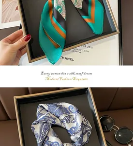 Detail showing two types of elegant paisley silk scarves with a smooth and silky texture