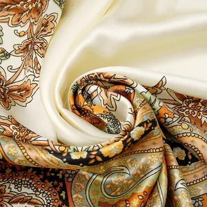 Close-up of satin imitation silk square scarf with intricate paisley and floral print.
