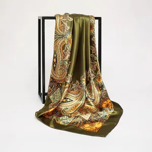 Detailed view of luxury olive green paisley print satin silk scarf with elegant drape