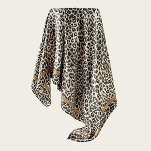 Detailed view of the leopard print pattern on a luxurious silk-like satin square scarf
