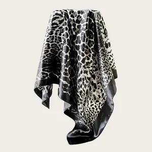 Detailed view of large leopard print satin silk-like square scarf showing soft elegant drape