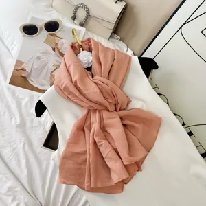 Elegant peach wrinkled cotton blend scarf styled with luxury fashion accessories