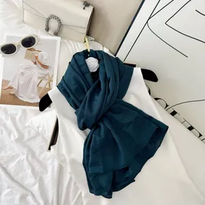 Elegant dark teal micro-elastic wrinkled scarf styled with white top and trendy bag