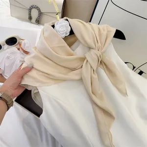 Detailed view of the soft cream crinkle cotton square scarf showing natural pleated texture