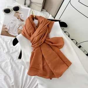 High-quality burnt orange crinkled cotton-blend scarf for women, textured detail view